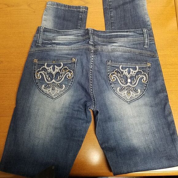 Liuce's size 7 blue jeans. Has whiskers  on front and back under knee. Embellish - Picture 1 of 9